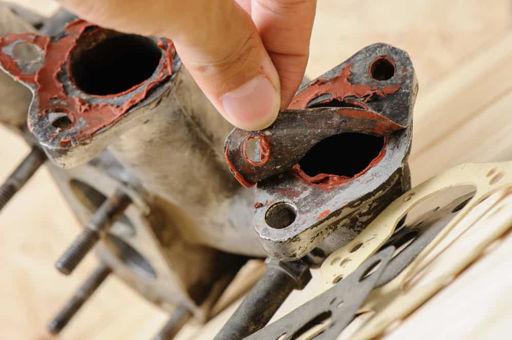 removing a gasket from an exhaust manifold