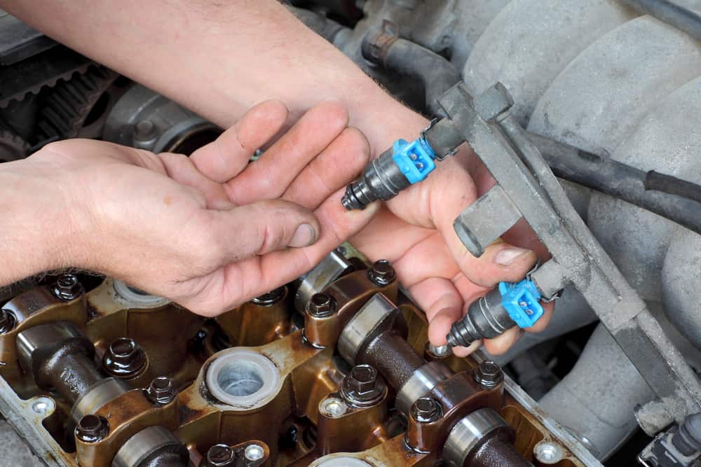 fuel injectors being taken out of an engine