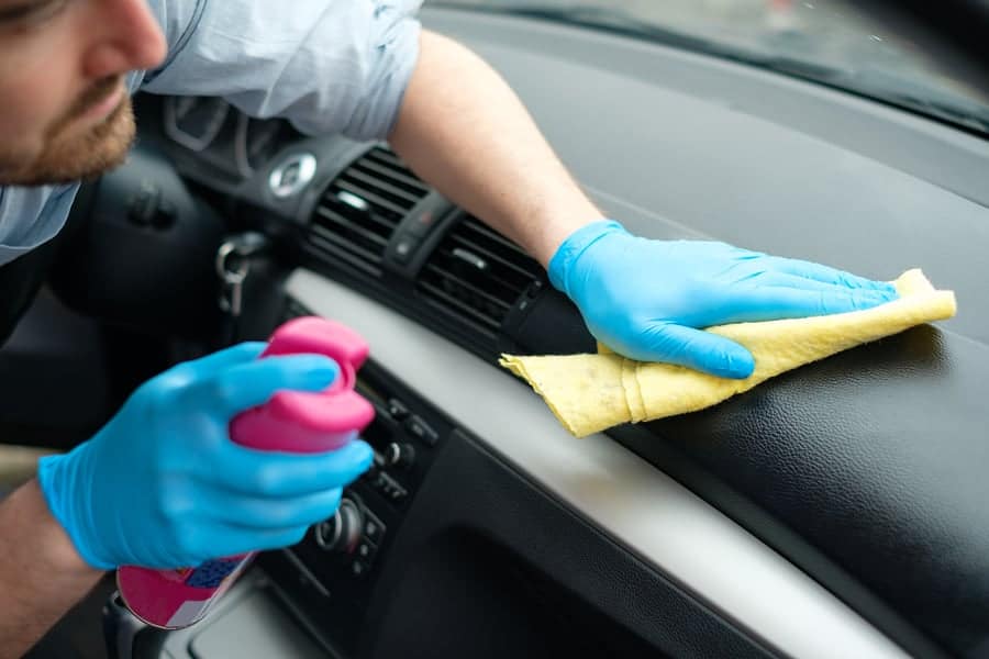 man cleaning car interior