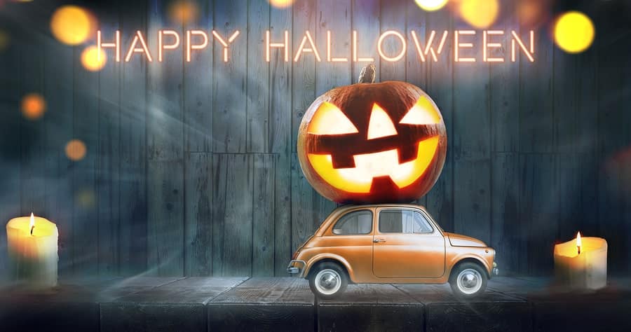 car delivering a scary pumpkin