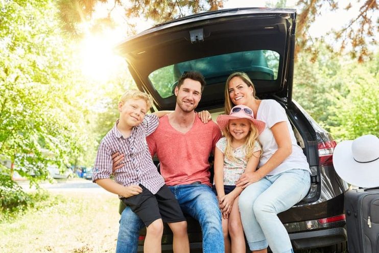 family sitting in a car