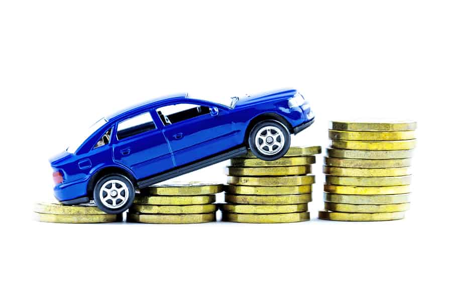 blue model car on piles of coins