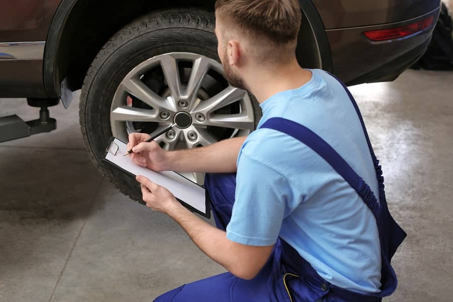 Mechanic looking at tyre markings