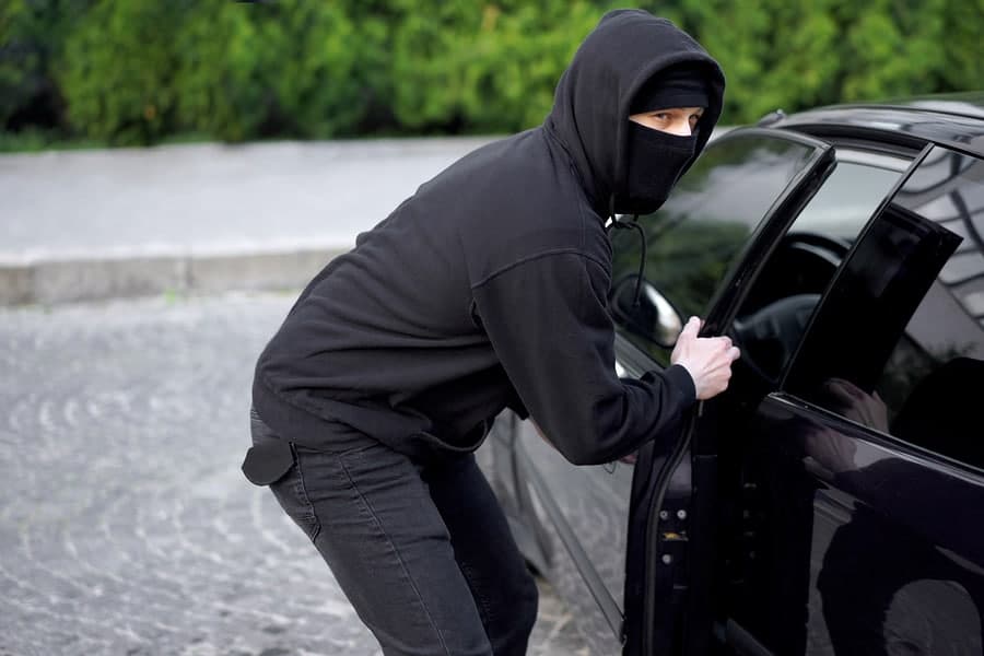 car thief breaking into a car