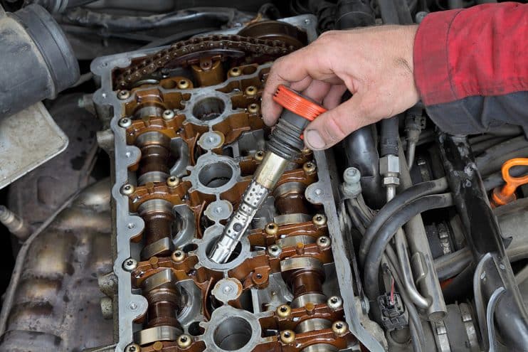 Mechanic replacing ignition coil