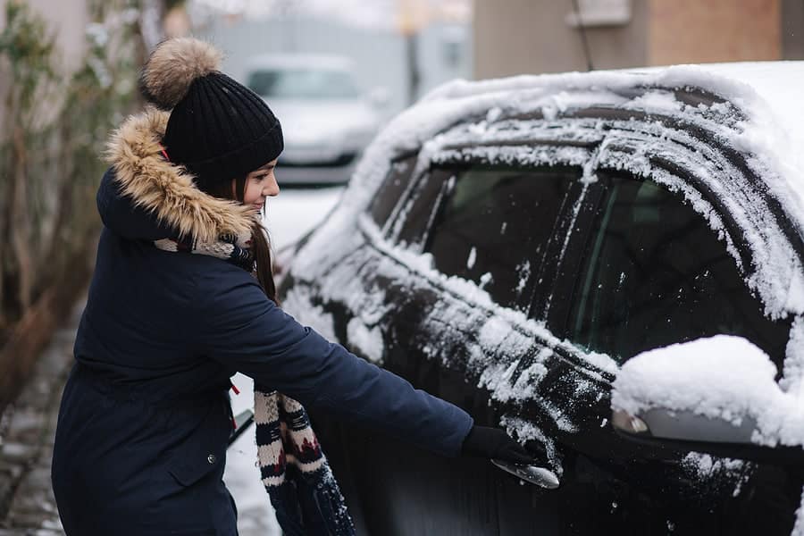 woman trying to open frozen doors