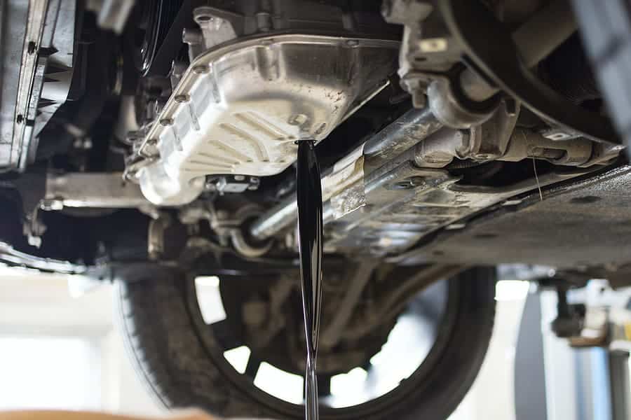 old oil being drained from a car engine.