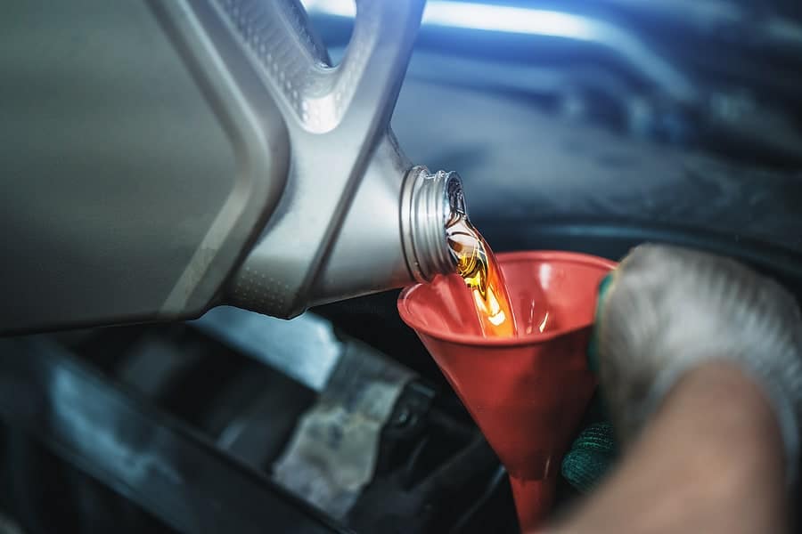 motor oil being poured into an engine