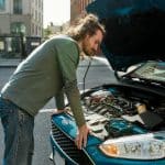 Young Man Standing Near His Car With Open Hood On The City Stree