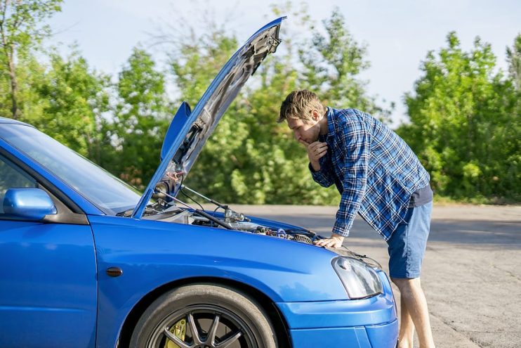 a man checking his juddering car