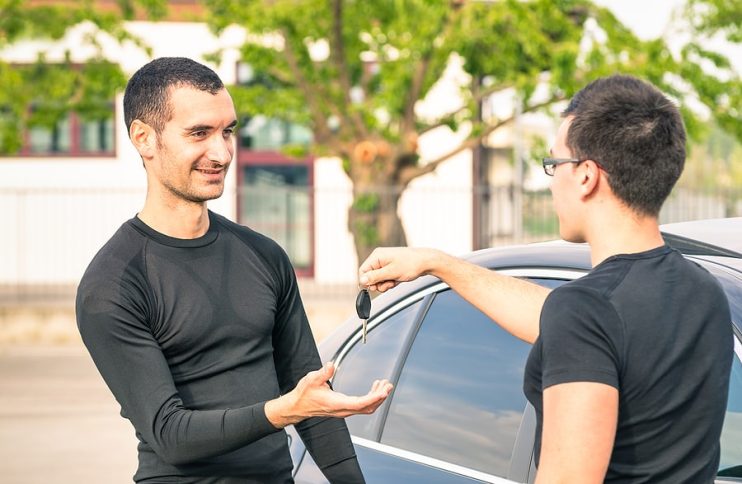 man selling his used car