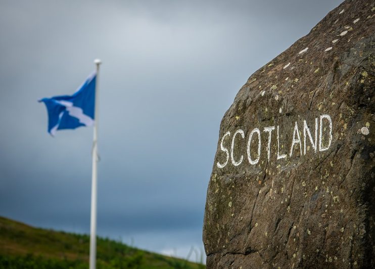 Scotland stone sign and flag