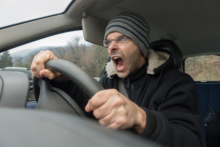 male driver getting angry behind the wheel