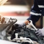 Mechanic Works On The Engine Of The Car In The Garage. Repair Se