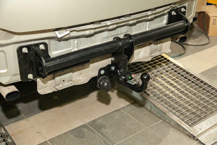 a tow bar being fitted to a car