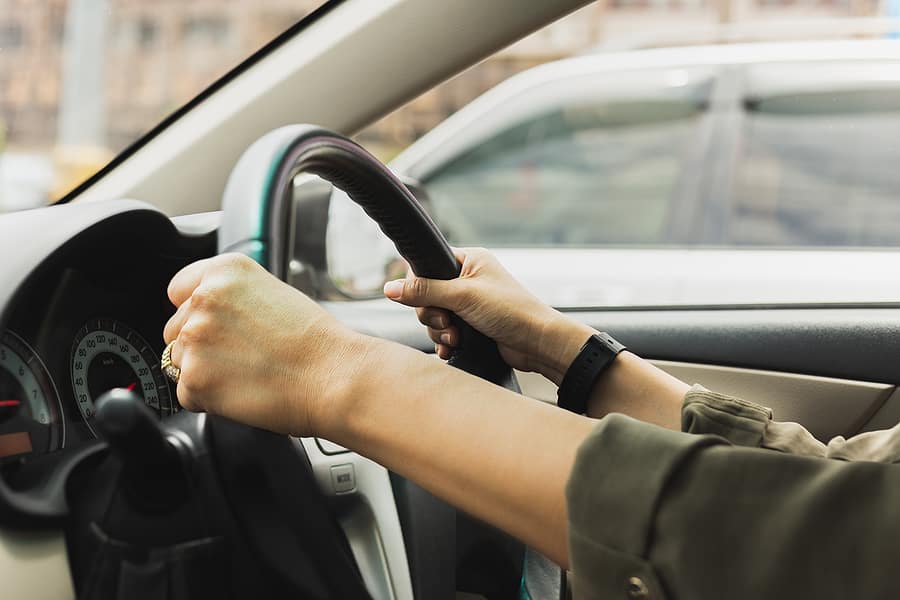 holding onto steering wheel as car is pulling