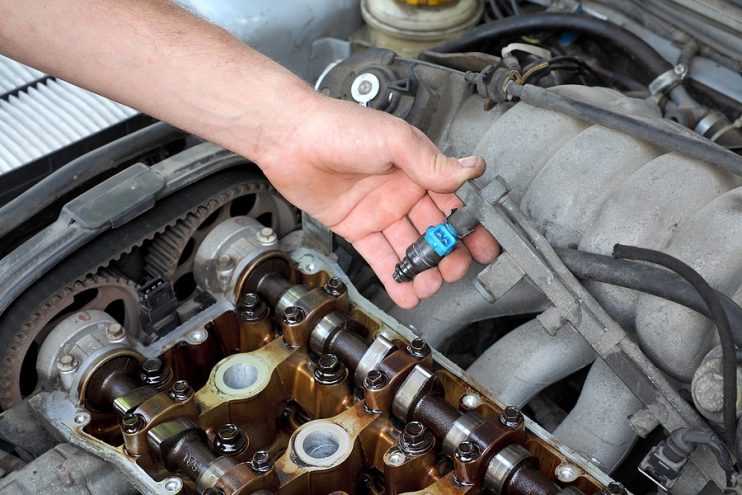 injector being removed from an engine