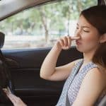 Young Woman Holding Her Nose Because Of Bad Smell In Car.