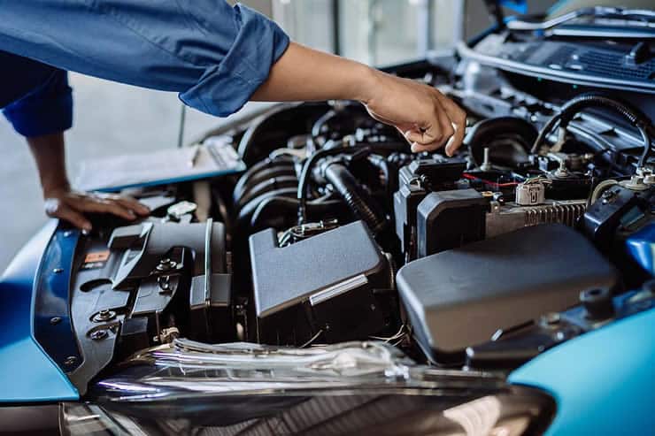 Mechanic examining engine