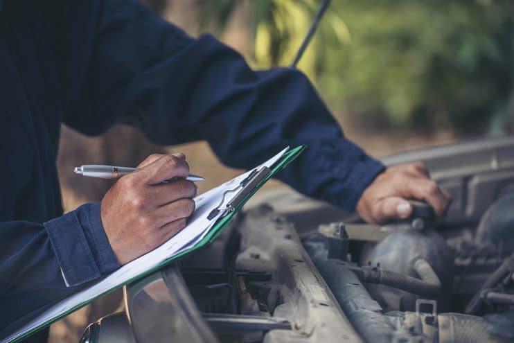 Mechanic servicing car