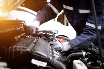 mechanic working on an engine to cure misfiring