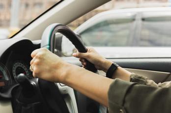 holding onto steering wheel as car is pulling